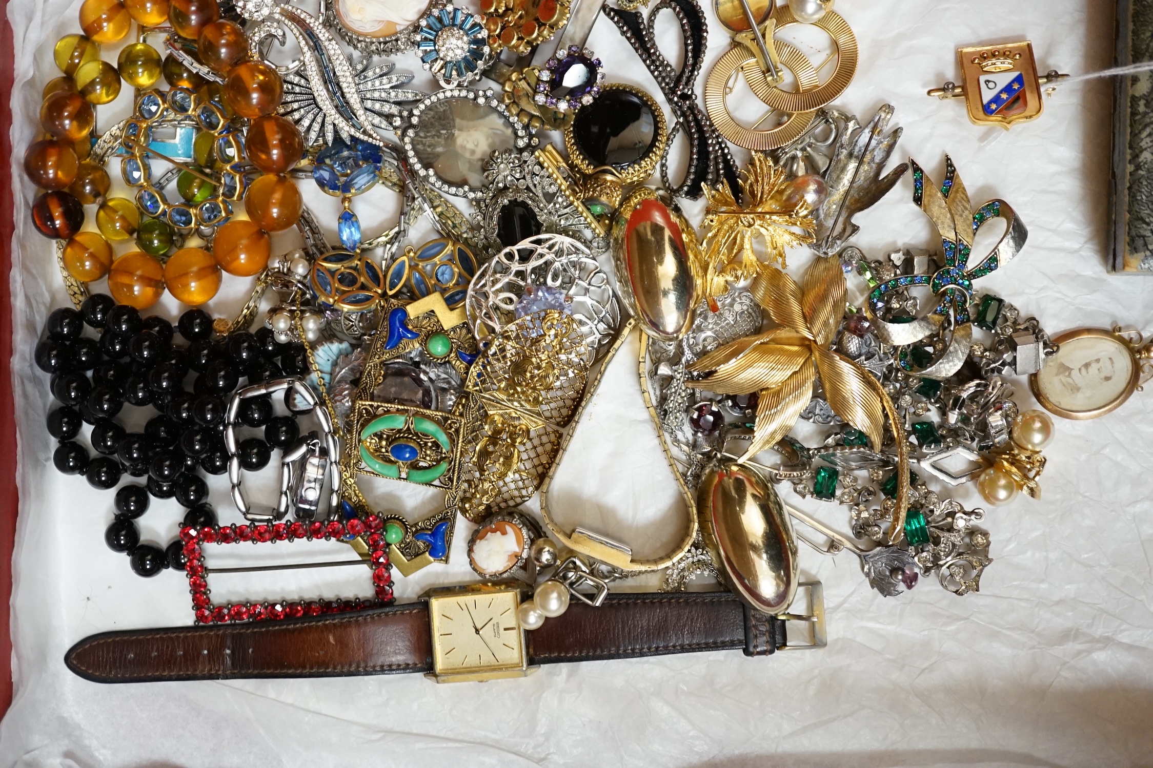 A large collection of costume jewellery, including a green and clear paste set necklace, a jet necklace, a silver and citrine cloak brooch, a yellow metal framed double portrait pendant, a yellow metal, enamel and rose c